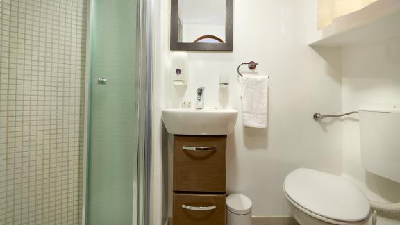 A modern bathroom on the Gulet Linda with a shower, washbasin and toilet.